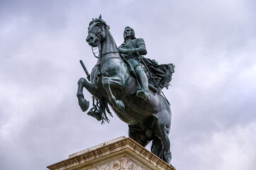 Fototapeta premium Ancient monument to Felipe IV in the Plaza of the Royal Palace, Madrid, Spain