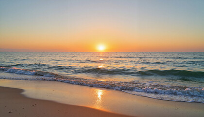 Fototapeta premium Serene sunrise over gentle waves at beach, peaceful beginnings