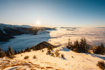 Winter hiking to Sina in Low Tatras National park near jasna is full of beautiful views. Sunset in Slovakia mountains with Chopok peak.