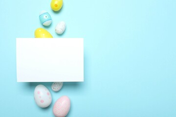 Happy Easter card. Easter eggs, paper card on blue background, top view