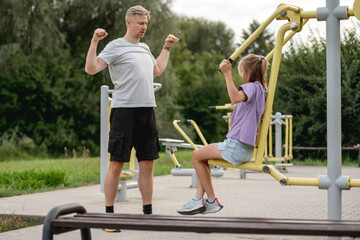 Father And Daughter Training Together At The Playground, Bonding Through Outdoor Activities