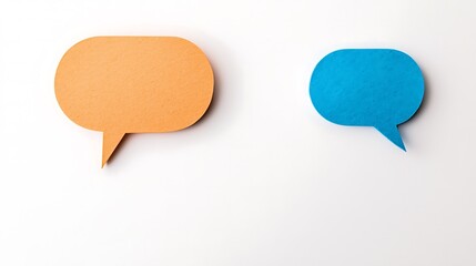 Two colorful speech bubbles, one orange and one blue, on a white background symbolize communication and conversation.