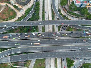 High-angle shot of a complex highway interchange with heavy traffic. Perfect for transportation, infrastructure, and urban development projects.