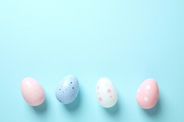 Easter decor concept. Top view photo of colorful eggs on pastel background 