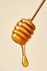 Honey dripping from a honey stick, close-up, minimalist style on a light background