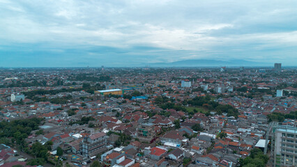 Stunning aerial shot of a city under a cloudy sky. Perfect for urban, travel, and real estate projects.