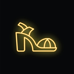 Neon sign illuminating a high heel sandal on a black background
