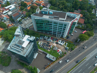 Drone shot of modern office buildings and a busy city street. Perfect for urban, business, and real estate projects.