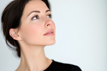 A woman is gazing upwards, her expression contemplative