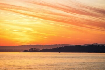 Naklejka premium Delicate watercolor strokes creating a gradient of warm orange and yellow colors, sunset scene, warm colors