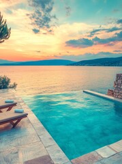 Fototapeta premium On a serene white marble floor at a hotel resort pool, two untaken rattan sunbeds and guest chairs are set, with a picturesque sunset sky in the background. The scene leaves room for copy and