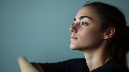 Fototapeta premium Contemplative Dancer in Dramatic Lighting at Ballet Studio - Ultra-Detailed Introvert Stock Photo Concept