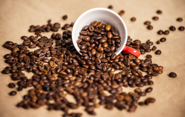 red cup with coffee beans on a light background.