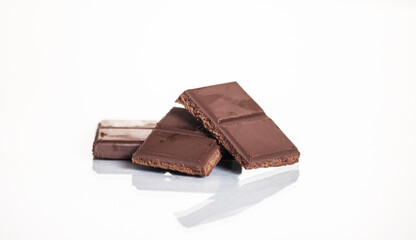 slices of delicious dark chocolate on a light background.