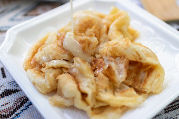 Roti with sweetened condensed milk. Popular street snack in Thailand.