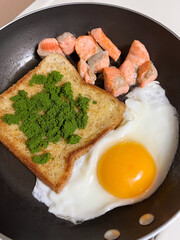 Easy with high protein one pan recipe, egg, salmon with bread and woffia on top.