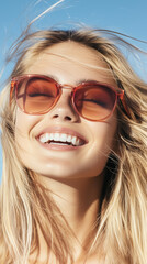 Fototapeta premium Cheerful young woman smiles with red sunglasses in summer
