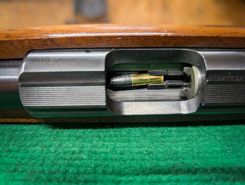 A small caliber rifle with a cartridge in the magazine, close-up, at a shooting range.