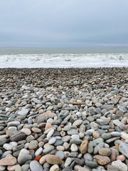 Landscape of sea and rocky beach at sunset