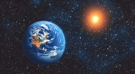 Obraz premium A blue, glowing Earth with a starry sky and the sun in the background, a panoramic view from space.