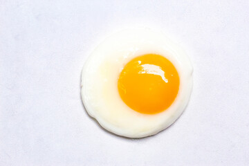 a fried egg isolated on a white background