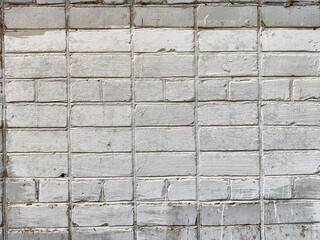 A weathered white brick wall with subtle texture showcasing an aged appearance and unique character