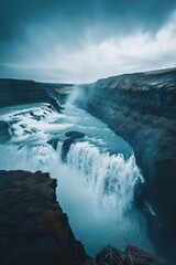 Breathtaking view of ocean waterfall under dramatic sky.