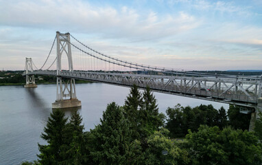 aerial view of the mid hudson bridge across the hudson river between poughkeepsie and highland new york (upstate valley) road highway cars walkway over suspension crossing at sunset
