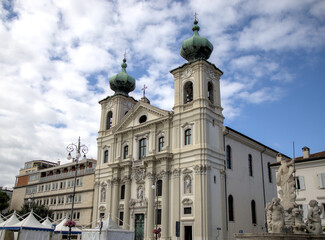 Fototapeta premium famous old church in gorizia italy (beautiful historic buildings in town square piazza) dome blue sky clouds history italian europe european