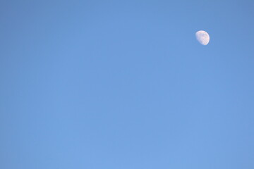 The Majestic Moon is Glowing Radiantly in a Clear Blue Sky, Creating a Serene Atmosphere
