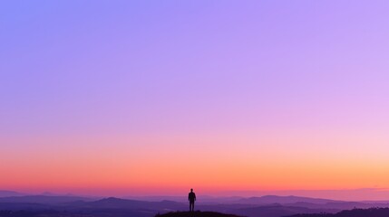 Embracing Dawn: Serene Silhouette of Man on Hilltop at Sunrise Conveying Confidence and Peaceful Energy