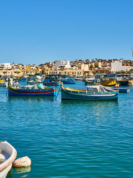 Traditional fishing boats in Marsaxlokk harbor. Marsaxlokk is one of the most popular tourist destinations in Malta