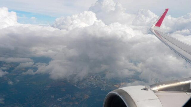 Aircraft wing white clouds? in blue? sky? view frow window airplane