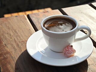 Enjoying a cup of hot Turkish coffee with mini Turkish delight lokum