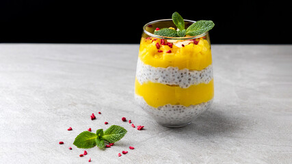Mango chia pudding in a glass. An excellent healthy vegan dessert with chia seeds. mango and coconut milk.