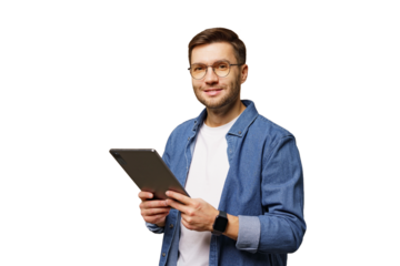 Young man in casual attire holds a tablet while smiling against a white background in a bright indoor setting