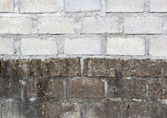 Background image of a brick wall with two sides of new foundation and old foundation. Background image and texture.