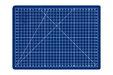 A small blue cutting mat with a white grid is isolated. Top view.
