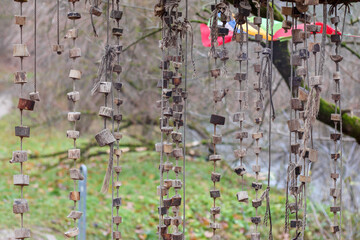 
Strings made of pieces of wood, hung from tree branches, creating an interesting and somewhat mystical scene.