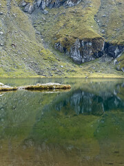 Tranquil Balea Lake nestled in the Carpathian Mountains. A reflection of nature's harmony and timeless beauty.