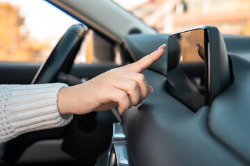A female driver using a phone navigator in the car,