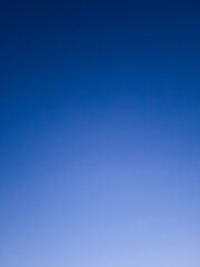 Clear blue sky background with gradient from lighten down to darken up.