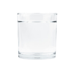 Clear glass filled with water on a plain background