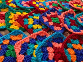 Crochet granny squares hobby handmade wool yarn objects decorative patterns om wooden background 