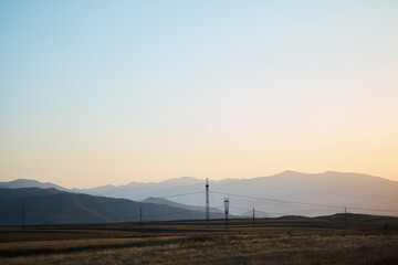 the power poles in the desert of Armenia with a view of the mountains