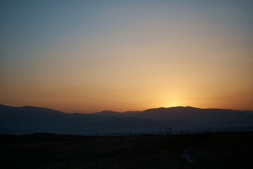 a sunset in the desert beyond the mountains, Armenia