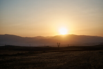 a sunset in the desert beyond the mountains, Armenia