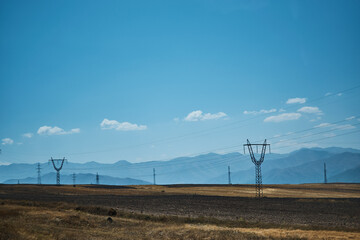 the power poles in the desert of Armenia with a view of the mountains