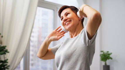 Woman dancing to music at home