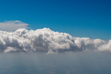 Aerial photograph of clouds outside of my airplane window on a cross country plane trip from Washington DC  to Austin Texas during a turbulent flight